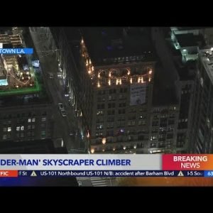 Spider-Man climbs downtown building